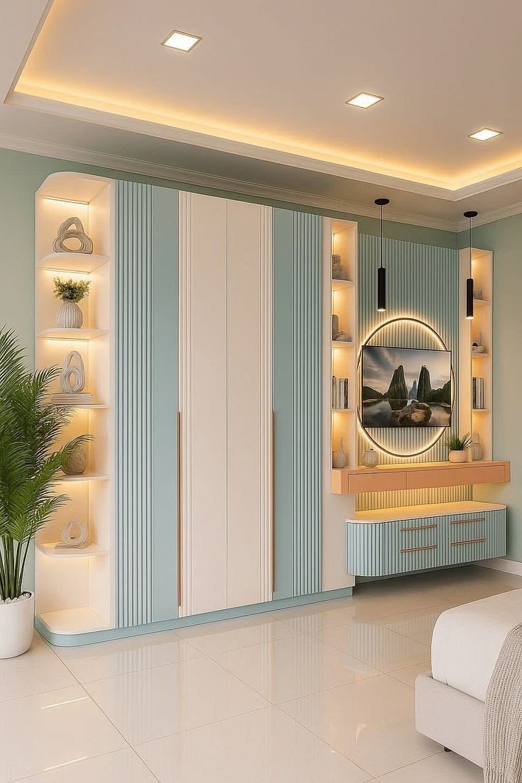 A sage-green bedroom wardrobe wall with a round mirror TV nook